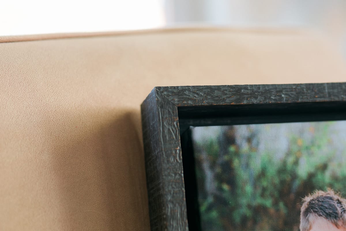 Close-up of the textured edge of a dark wood frame