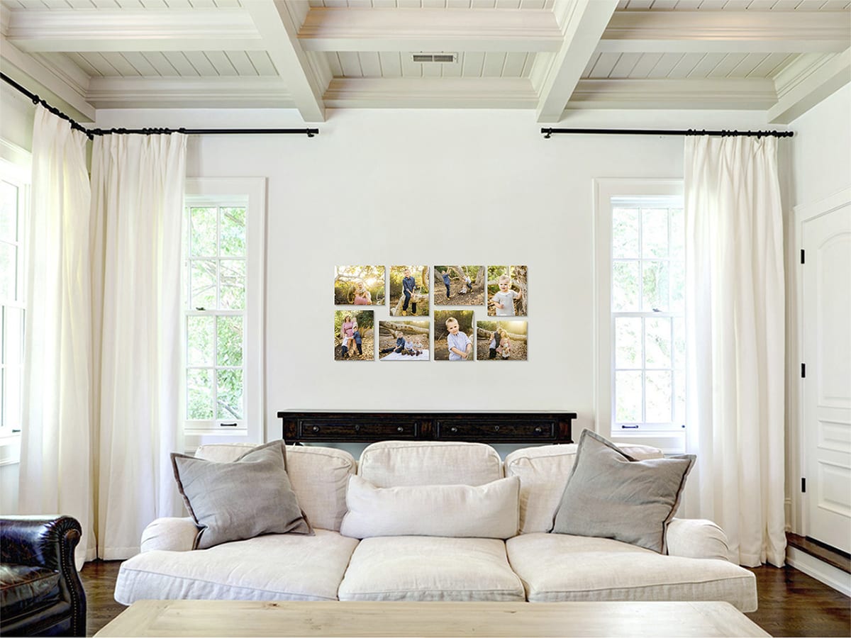 Living room with a framed wall gallery of family portraits above a white sofa