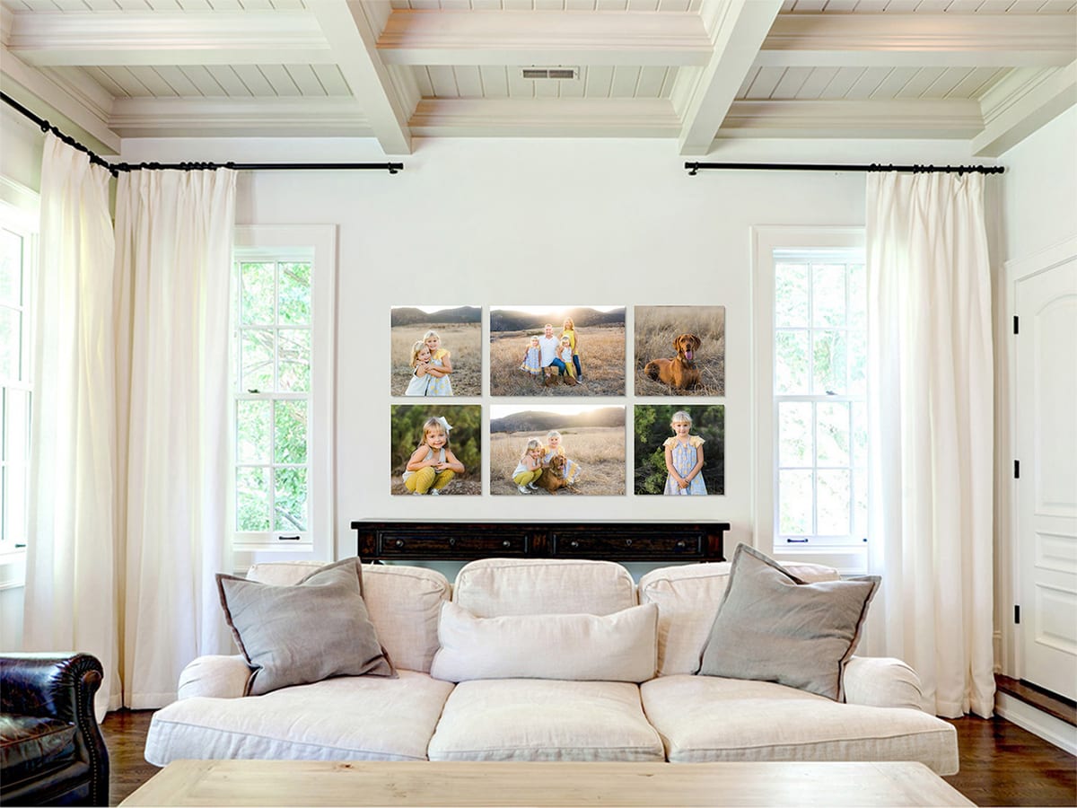 Living room with a six-photo wall gallery of family portraits above a white sofa